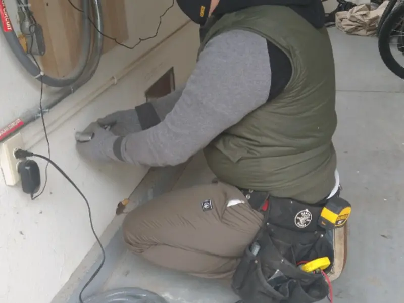 Electrician performing outlet wiring in a Doylestown garage
